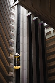 Modern villa elevator shaft with glass walls illuminated by soft natural light.