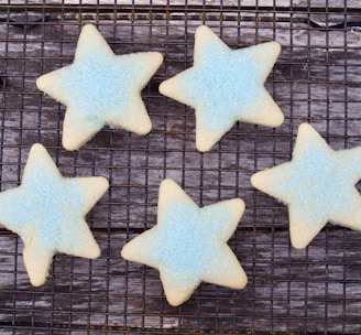 four star shaped cookies on a cooling rack