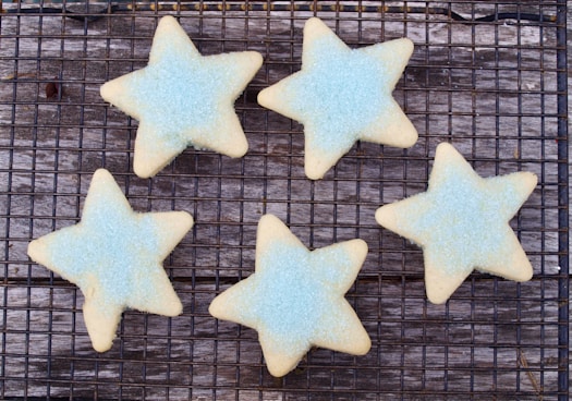 four star shaped cookies on a cooling rack