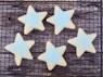 four star shaped cookies on a cooling rack
