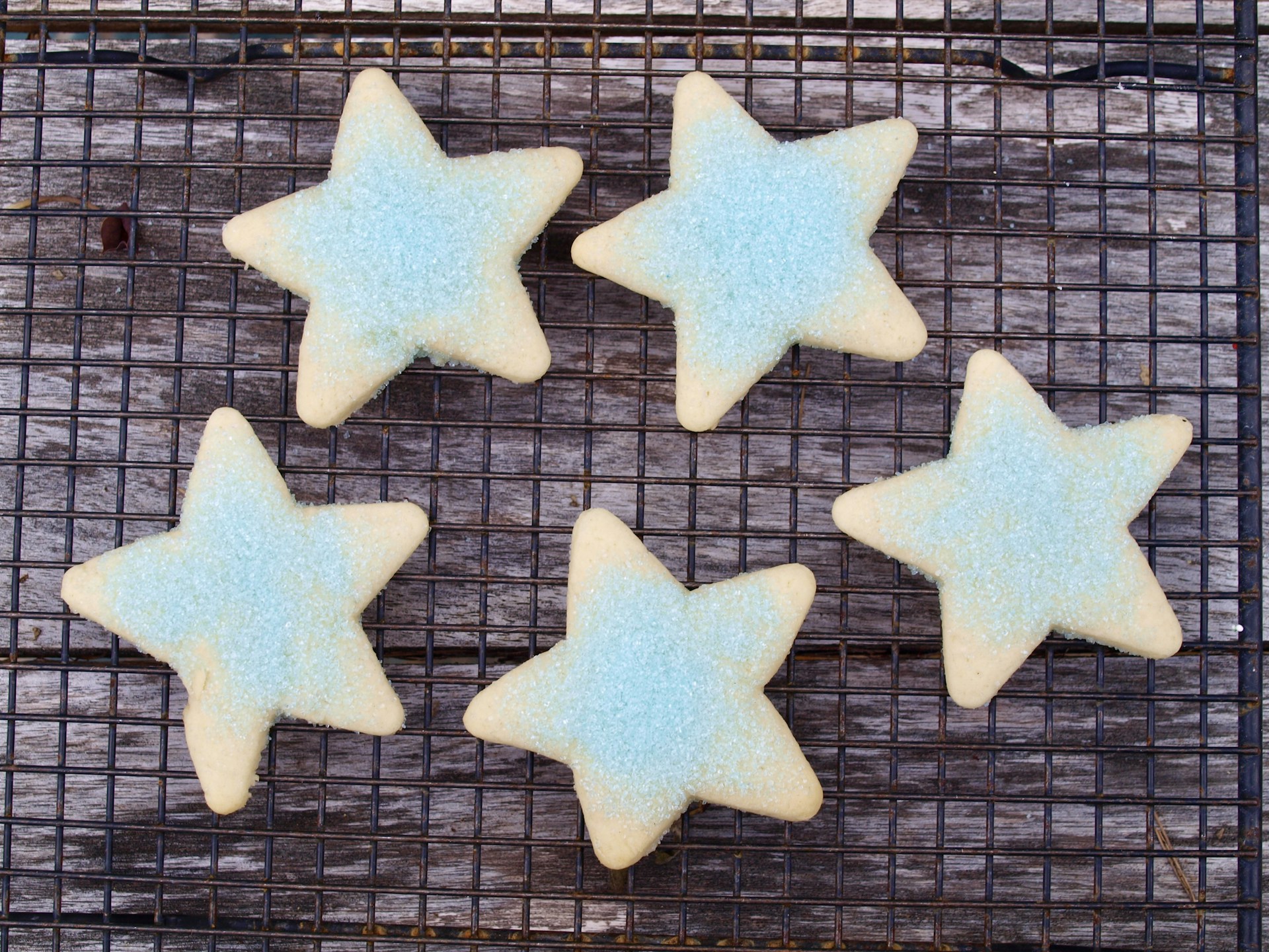 four star shaped cookies on a cooling rack
