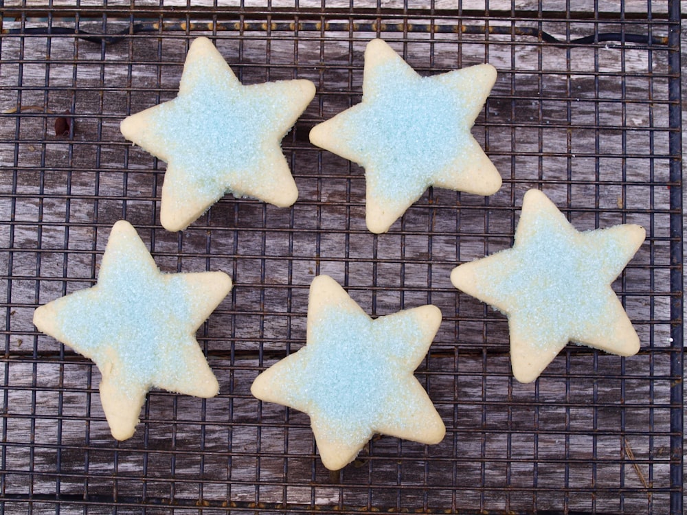 four star shaped cookies on a cooling rack