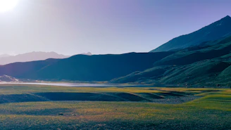 A serene landscape with rolling hills and a clear blue sky, symbolizing growth and exploration.