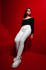 A model wearing a bold, statement outfit against a colorful backdrop.