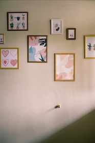 A collection of vibrant seasonal art prints displayed on a wall.