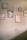 A wall adorned with several framed artworks, featuring abstract designs and illustrations of plants. The frames vary in size and color, and are neatly arranged, creating an aesthetically pleasing display.
