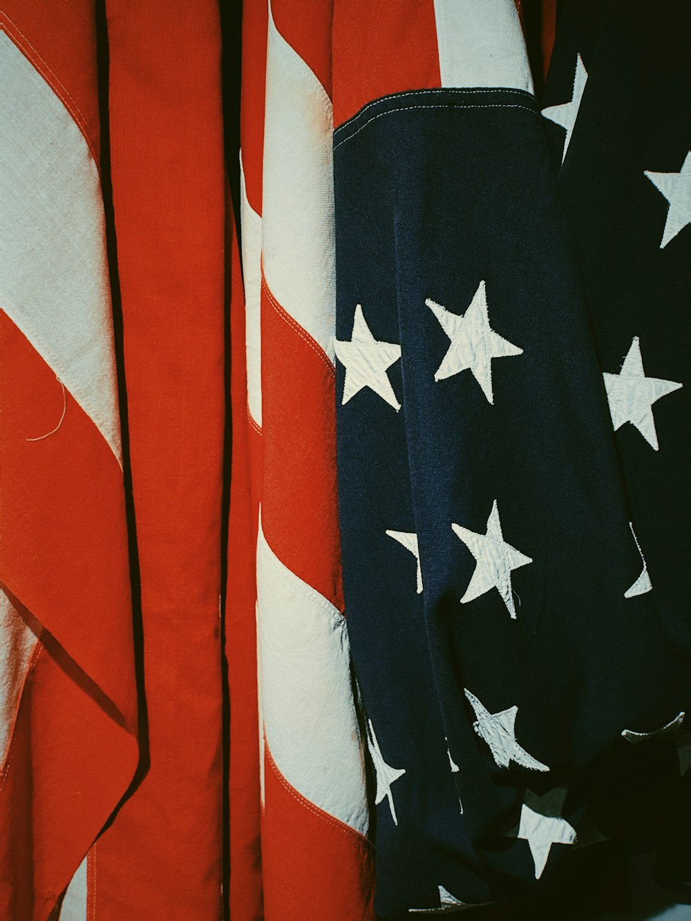 a close up of an american flag and a red white and blue flag