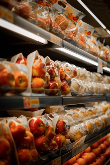 a display in a grocery store filled with lots of apples