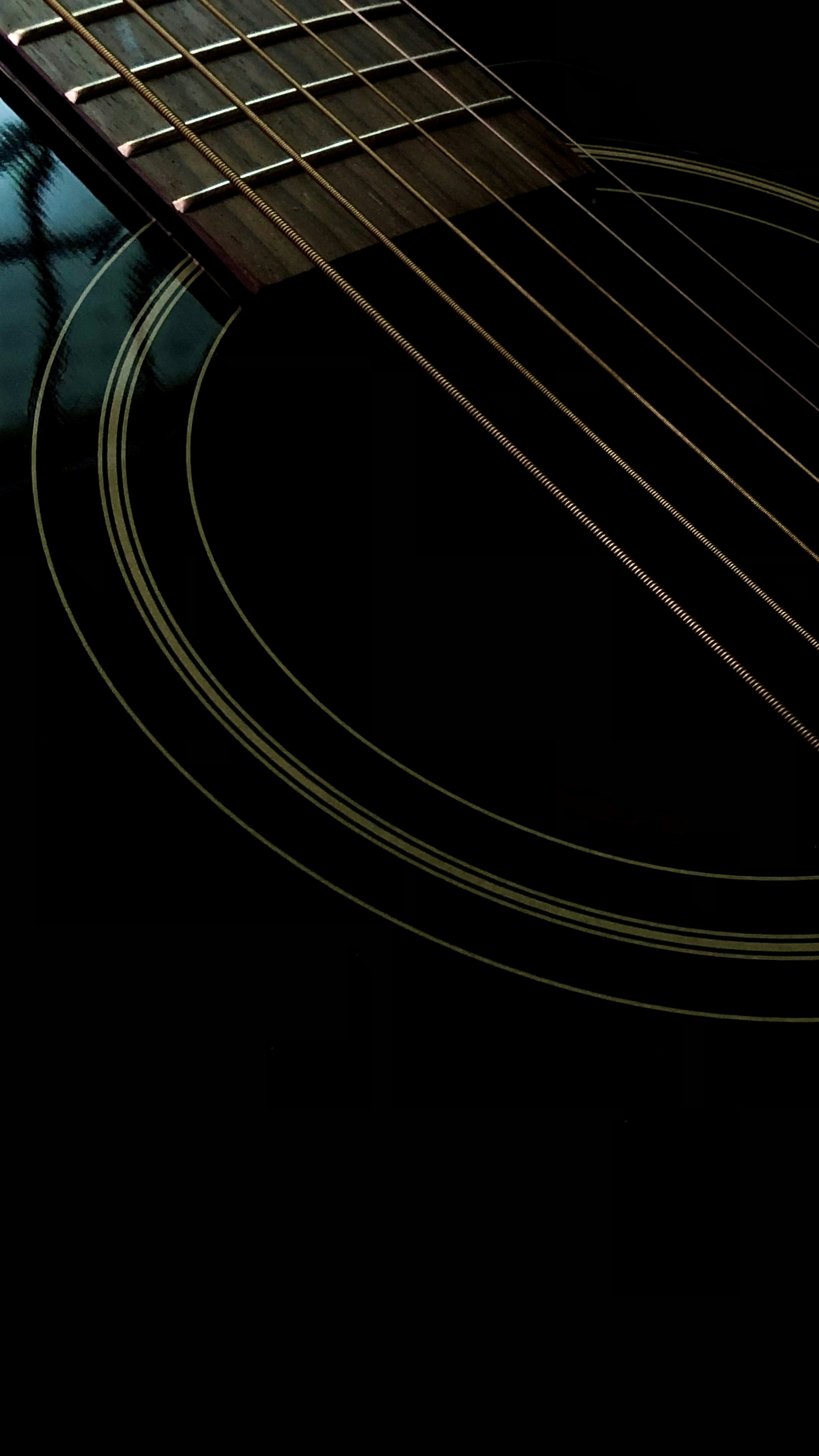 a close up of an acoustic guitar's frets