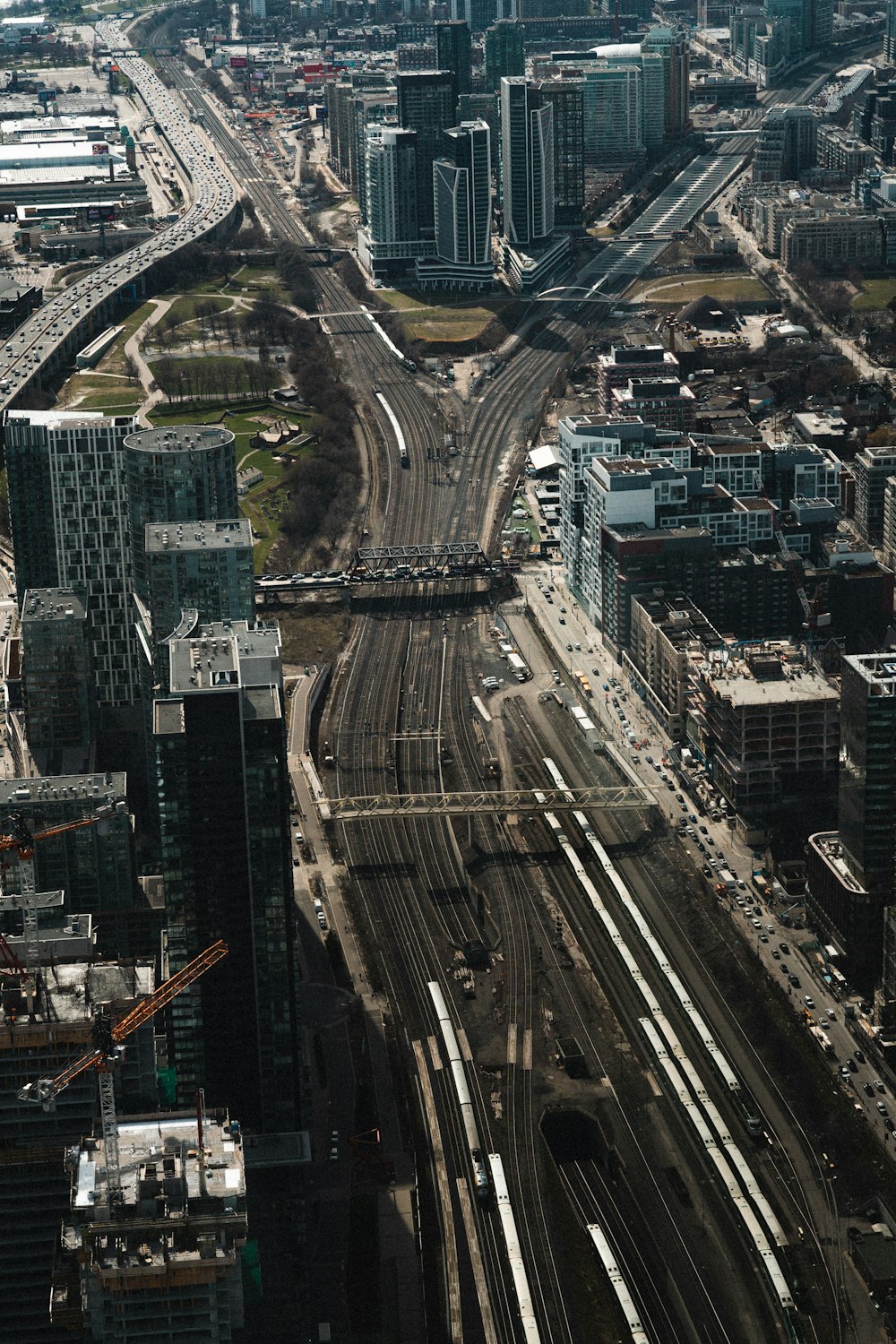 an aerial view of a city with train tracks