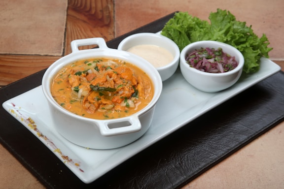 A beautifully arranged plate of herbal soup.