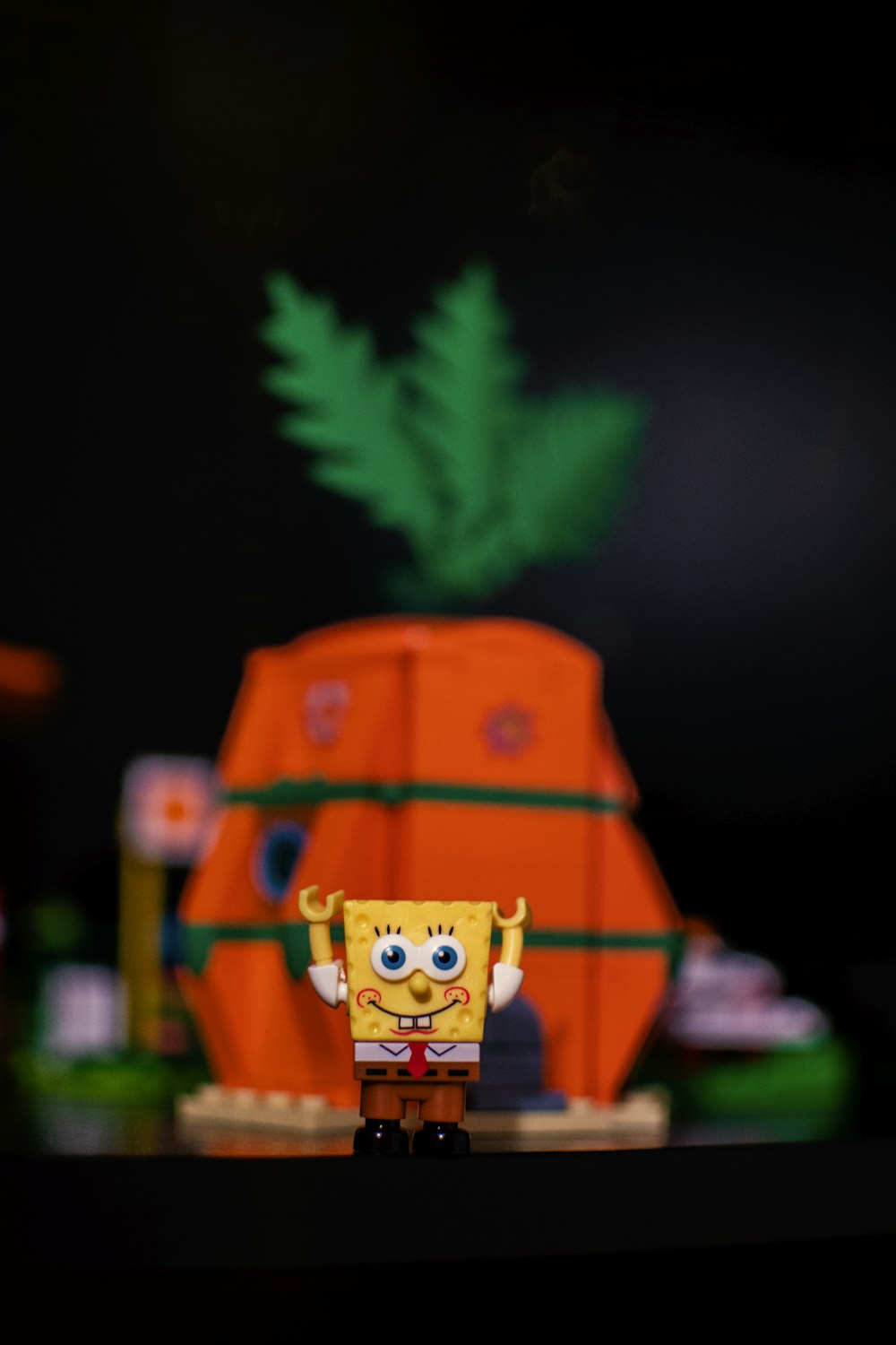 a toy spongebob is standing on a table
