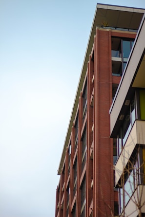 Wide shot of a completed brick facade with modern architectural design.