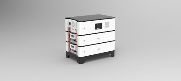 A three-tiered, white rectangular electrical device with black accents, featuring various input and output ports, vents, and a digital display on the side. Each tier appears to be a separate module, with visible electrical connections and indicators.