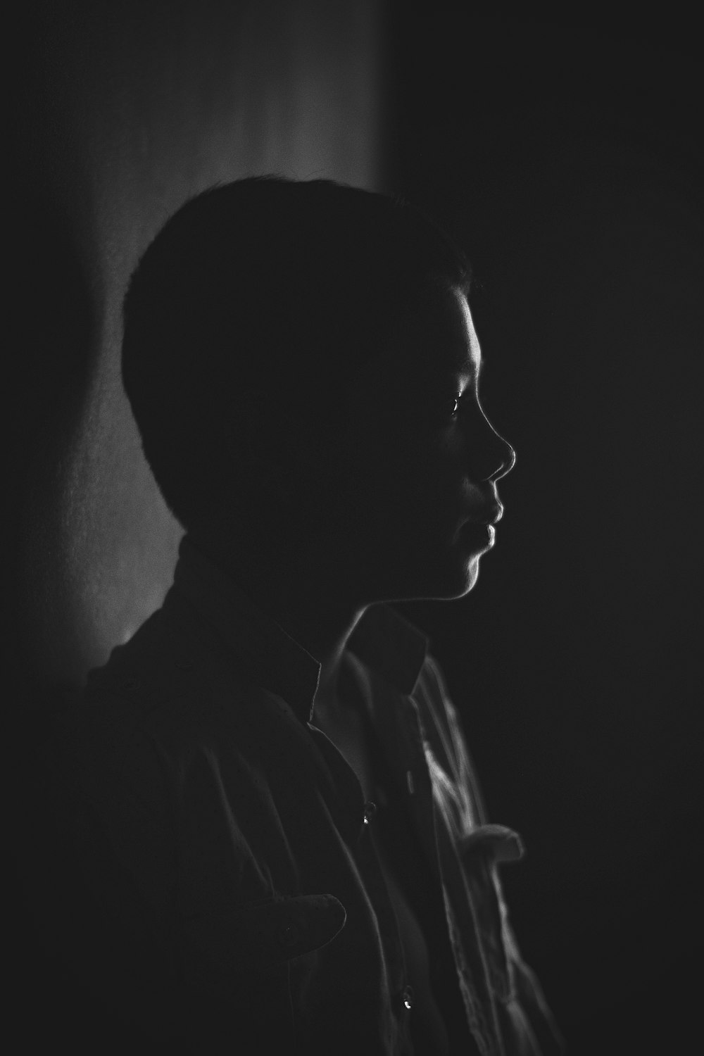 a black and white photo of a person in the dark