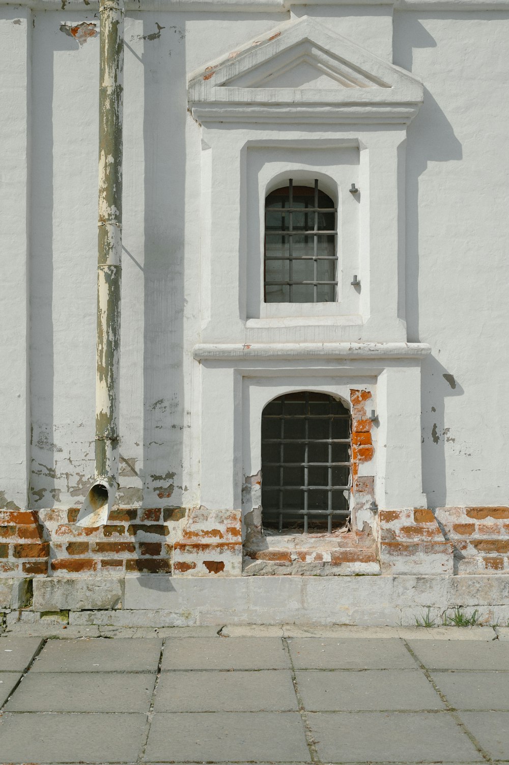 a white building with a red fire hydrant in front of it