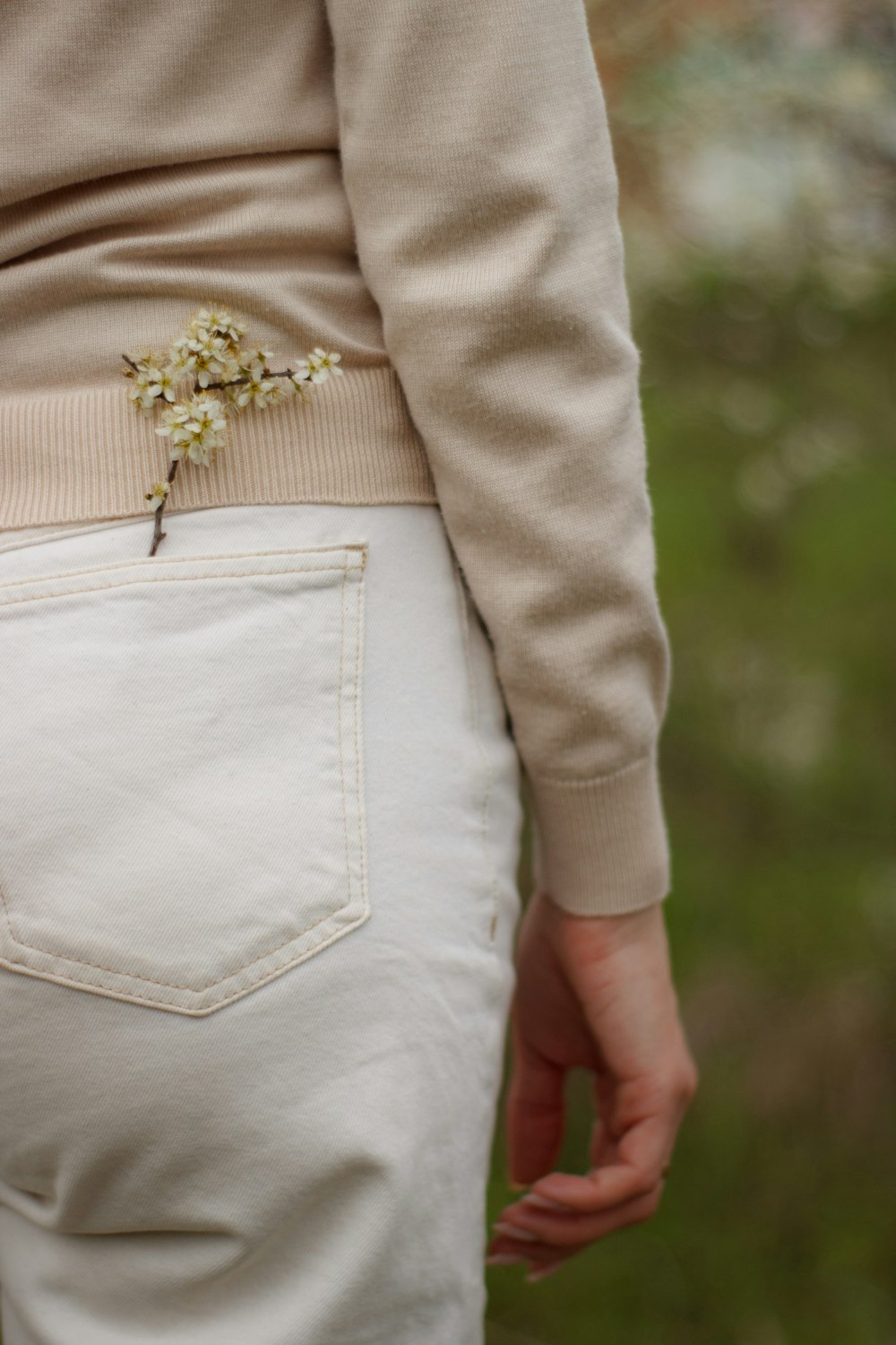 a close up of a person wearing white pants