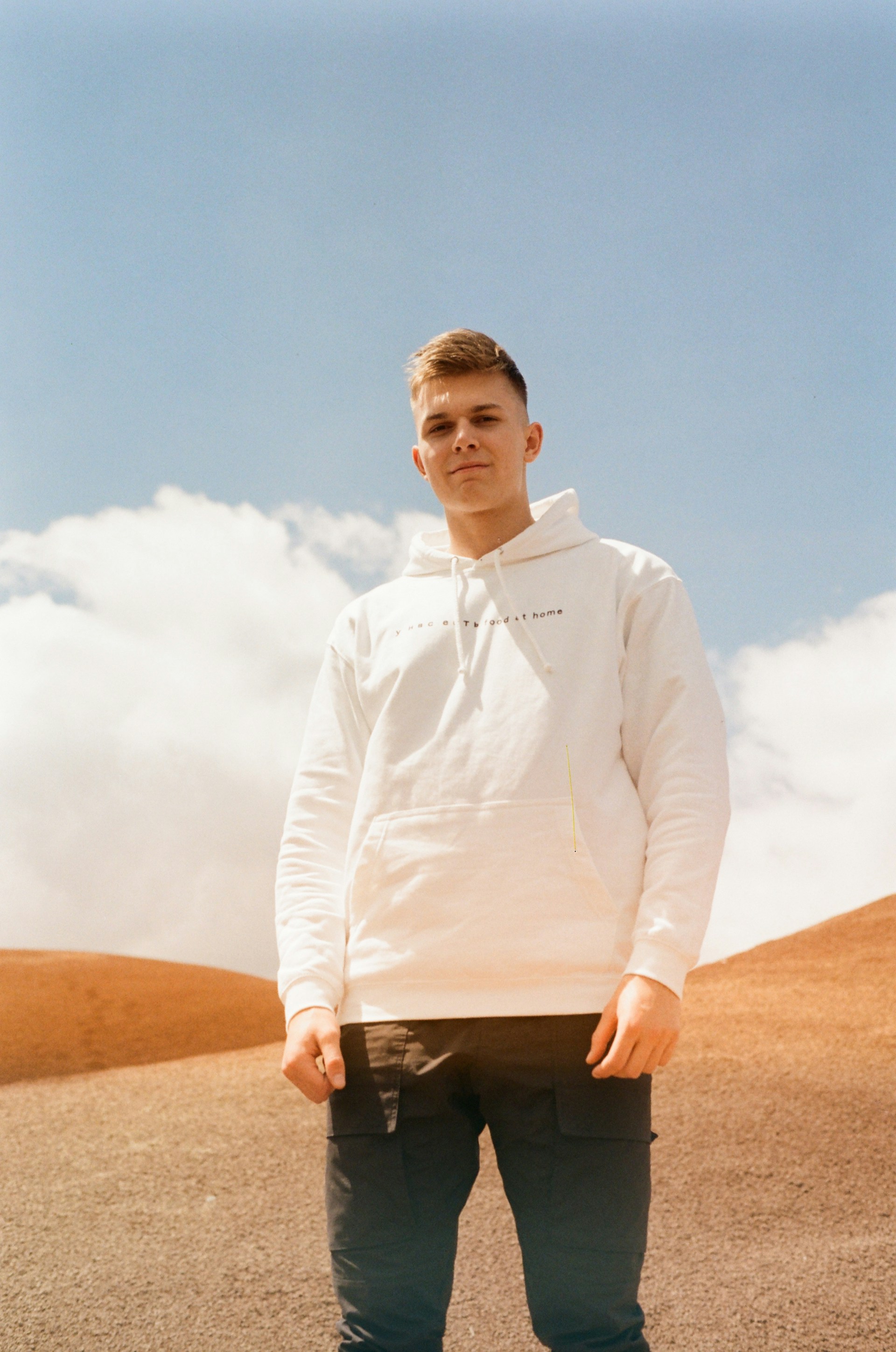 woman wearing yellow long-sleeved dress under white clouds and blue sky during daytime