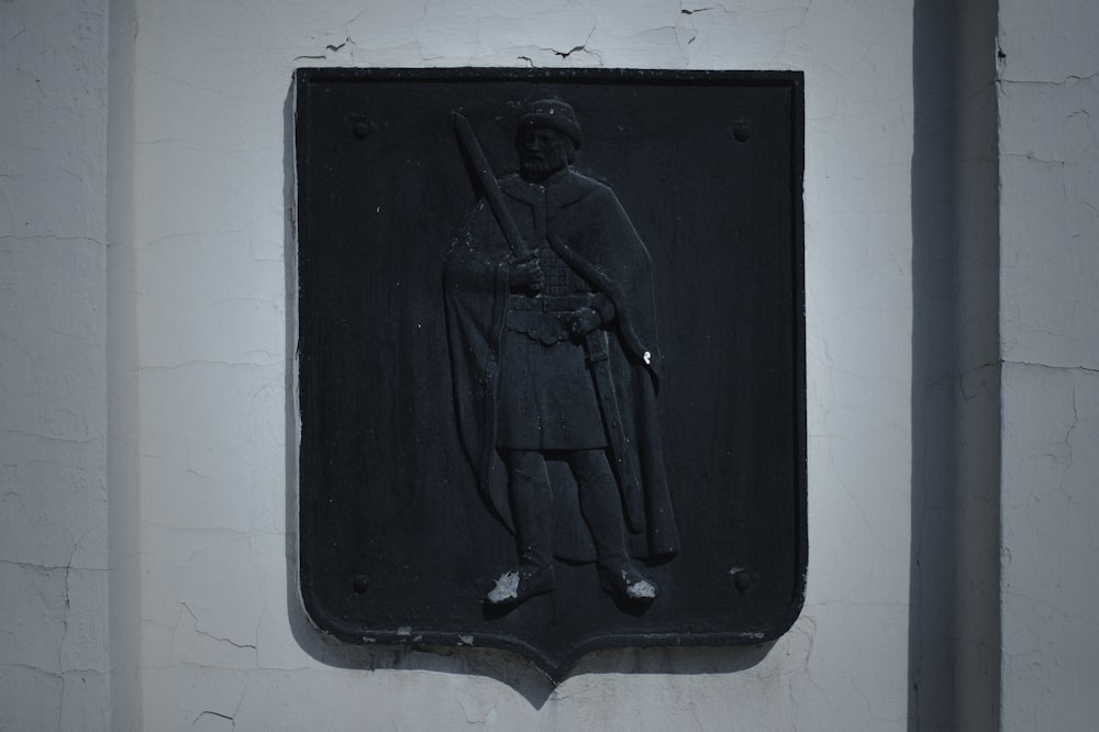 a plaque of a soldier on a white wall