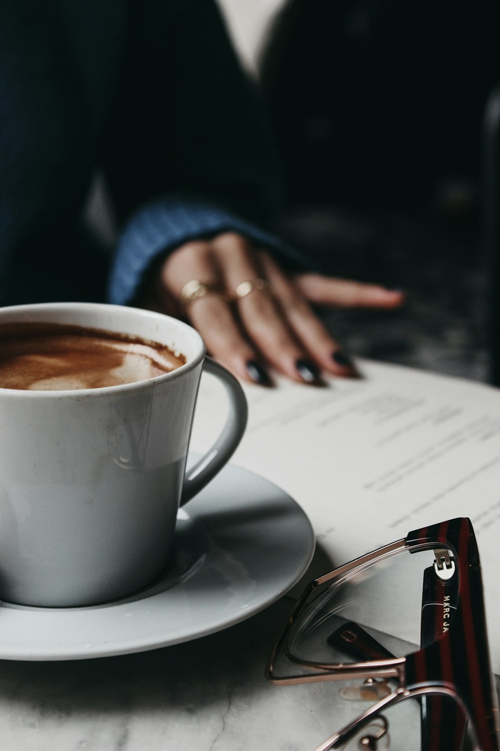 a cup of coffee sitting on top of a white saucer