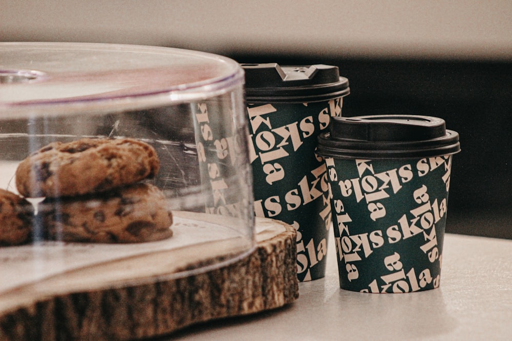 a stack of cookies sitting on top of a table next to a cup of coffee