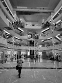 Interior shot of a modern shopping arcade featuring bright lighting and clean lines.