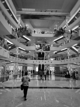 Interior shot of a modern shopping arcade featuring bright lighting and clean lines.