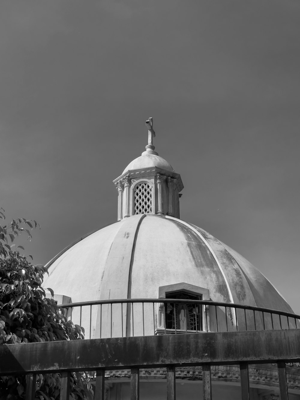 a black and white photo of a dome with a cross on top