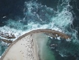 Engineers inspecting a newly installed seawall protecting a vulnerable beach.