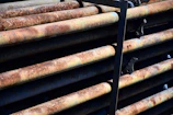 Close-up of industrial metal pipes stacked in a warehouse