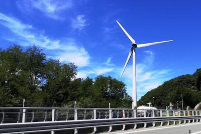 Graph showing rising website traffic with wind turbines in the background under a clear blue sky.