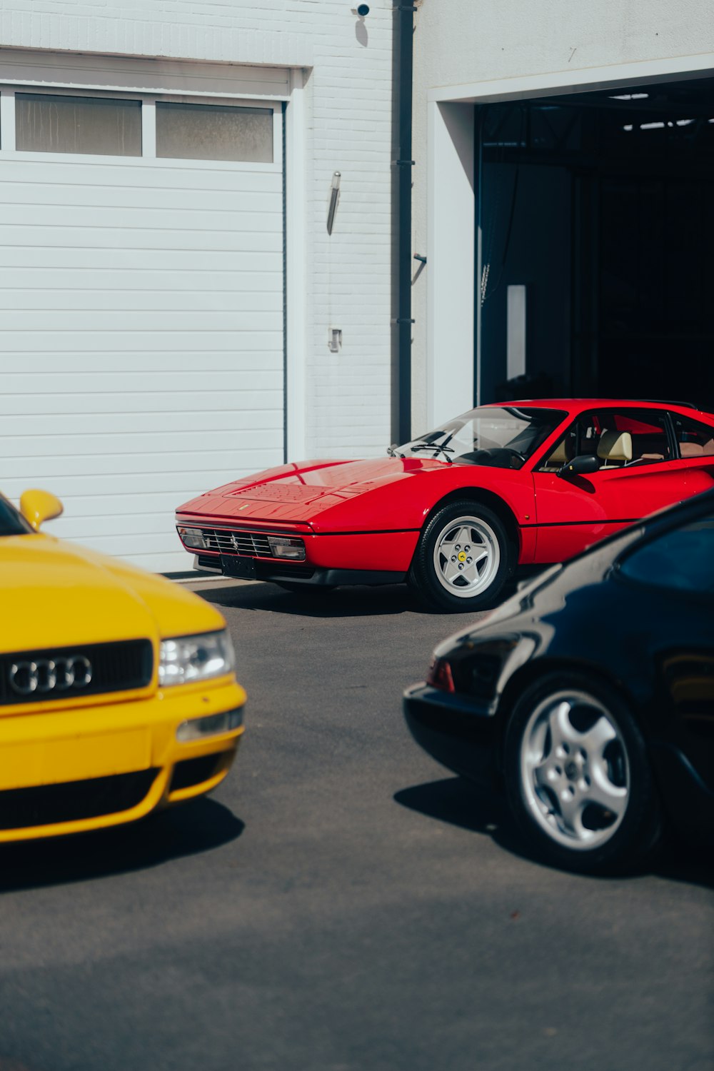 a group of cars parked in front of a garage