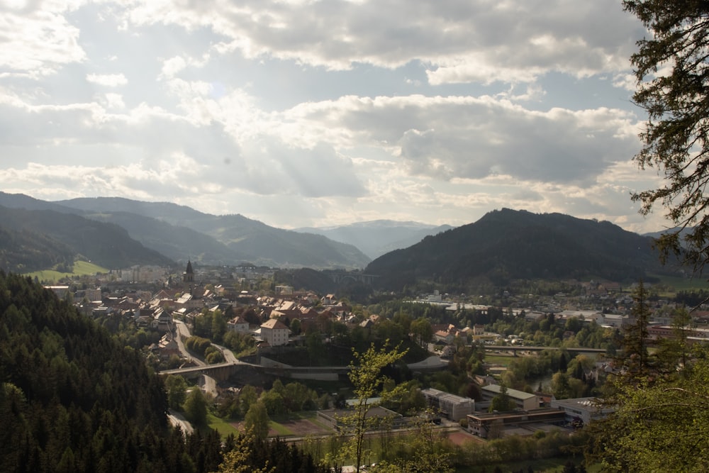 a scenic view of a small town in the mountains