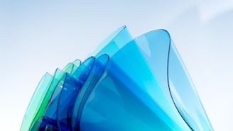 An arrangement of translucent floating shapes in varying shades of blue with subtle reflections