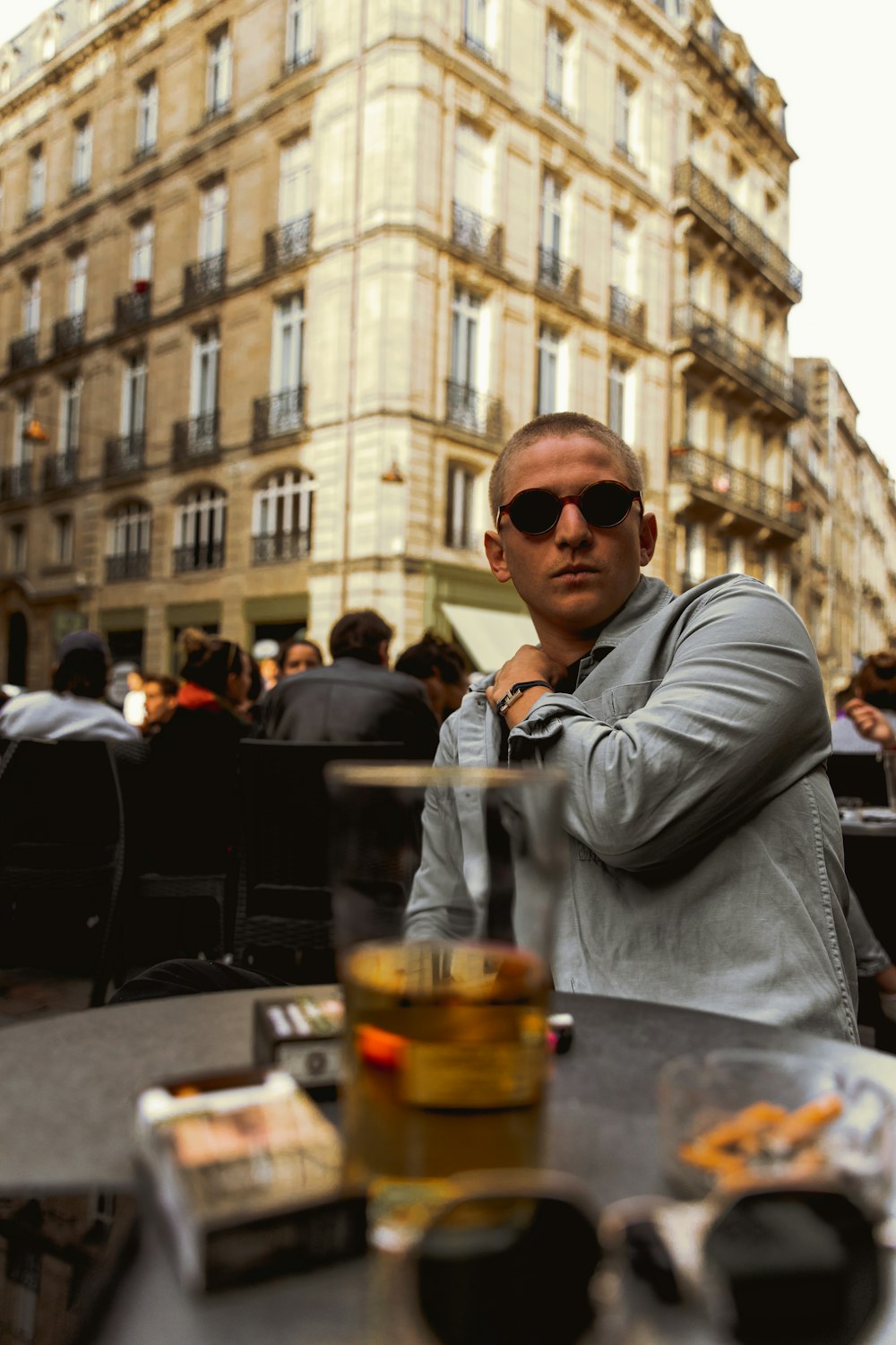 a man sitting at a table in front of a building