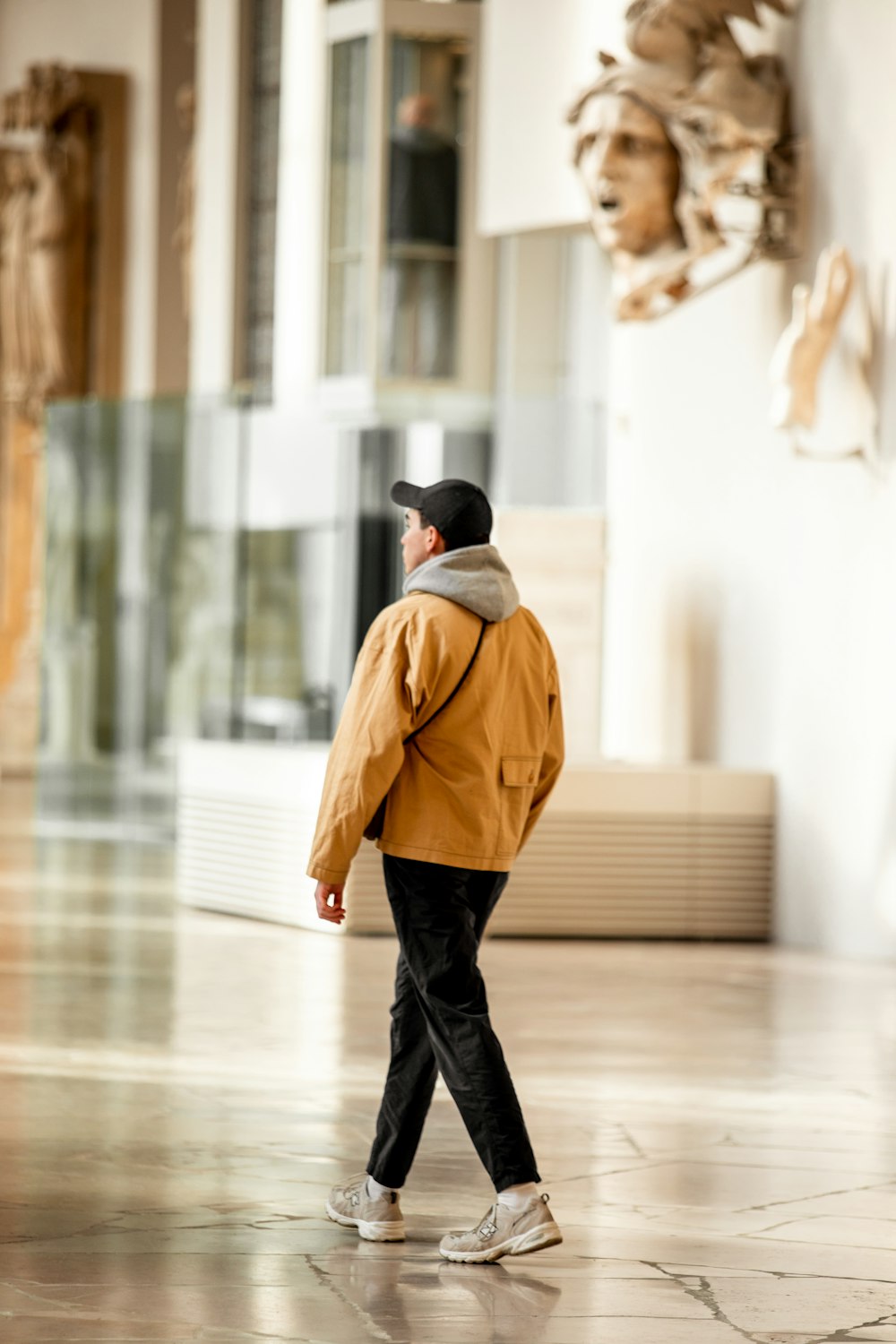 a man in a yellow jacket is walking through a building