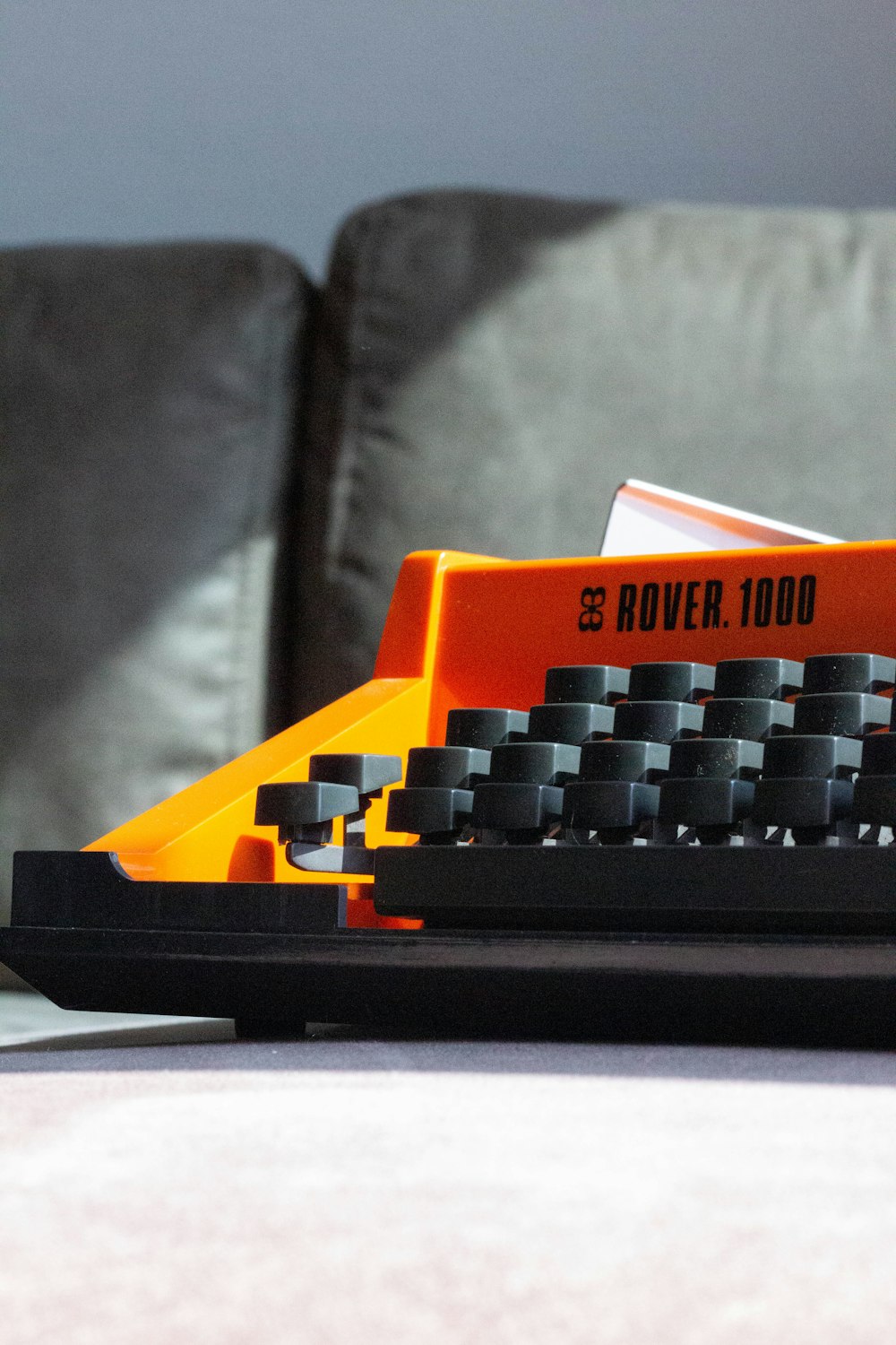 an orange and black toy typewriter sitting on a table