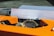 A close-up of a typewriter with a piece of paper inserted, featuring the words 'creativity is key' typed on it. The typewriter is prominently orange, with visible mechanical parts.