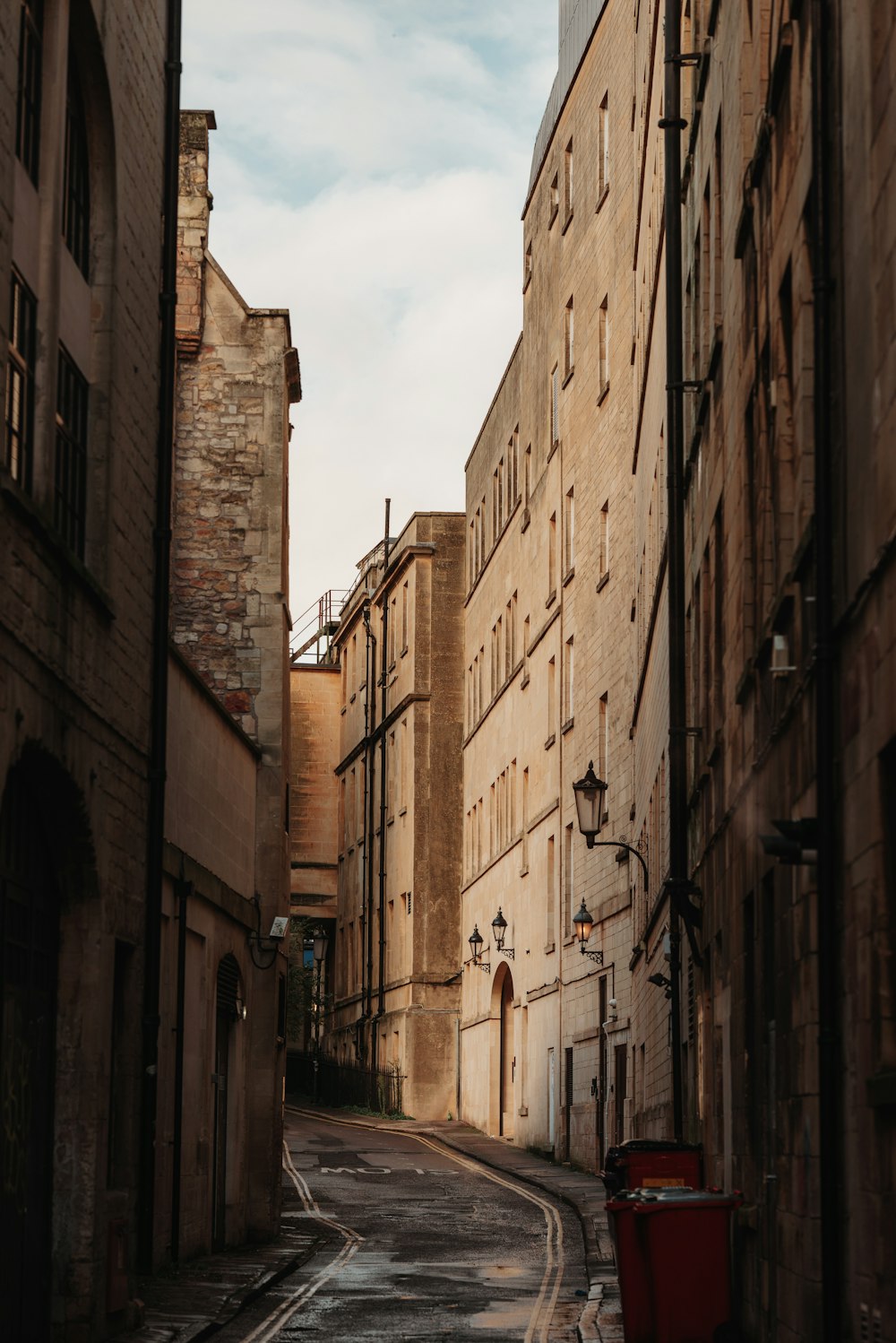 a narrow street with a few buildings on both sides