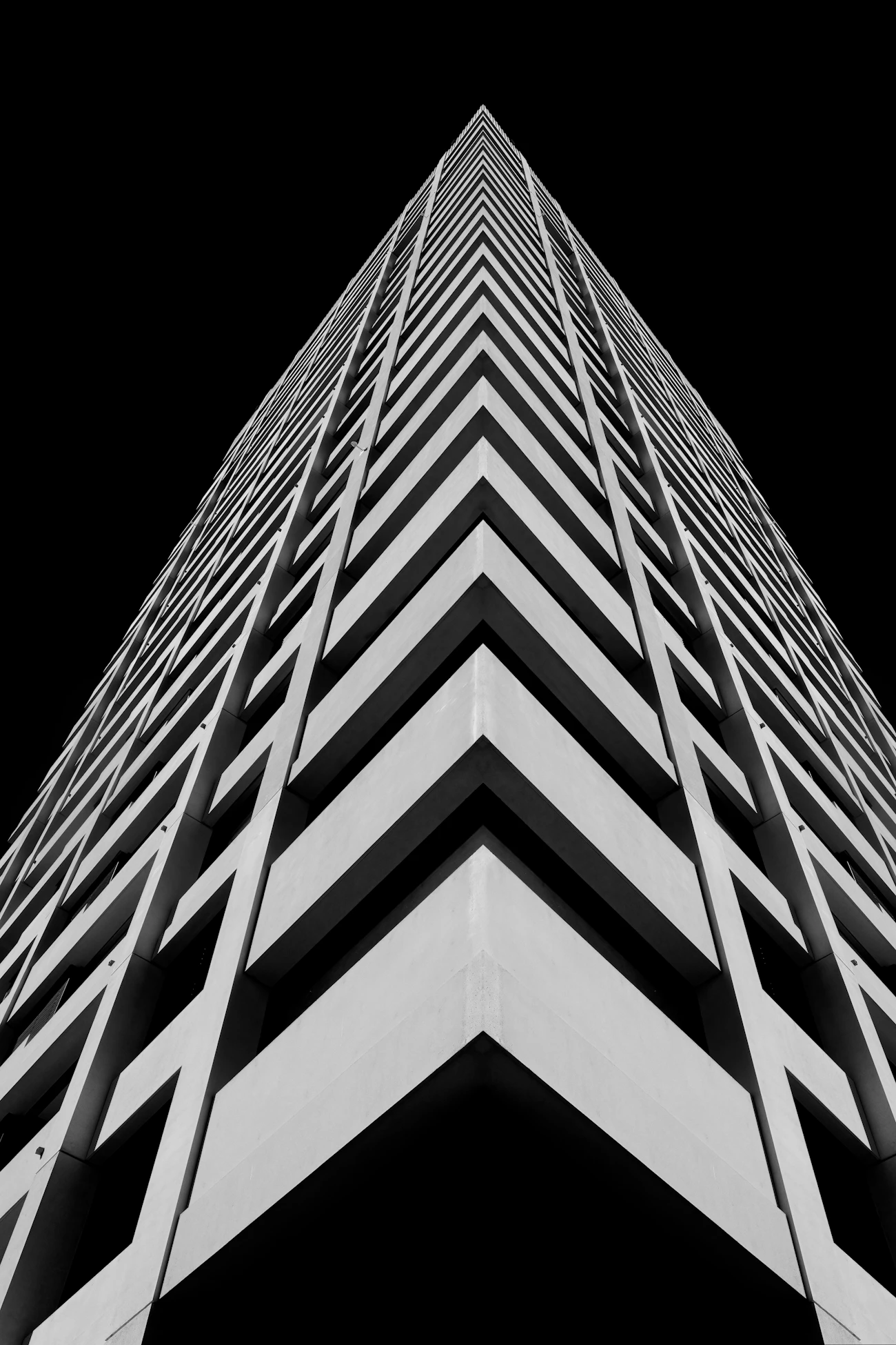 Monochrome architectural photograph of a modern tower's repeating structure