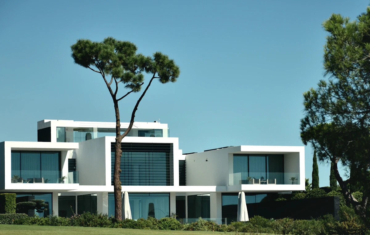 Large villa exterior with tree and driveway