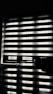 Horizontal blinds partially cover a window, creating a pattern of alternating light and shadow. Below the window, there is a reflective surface, possibly a table, displaying the same pattern along with a few small objects.