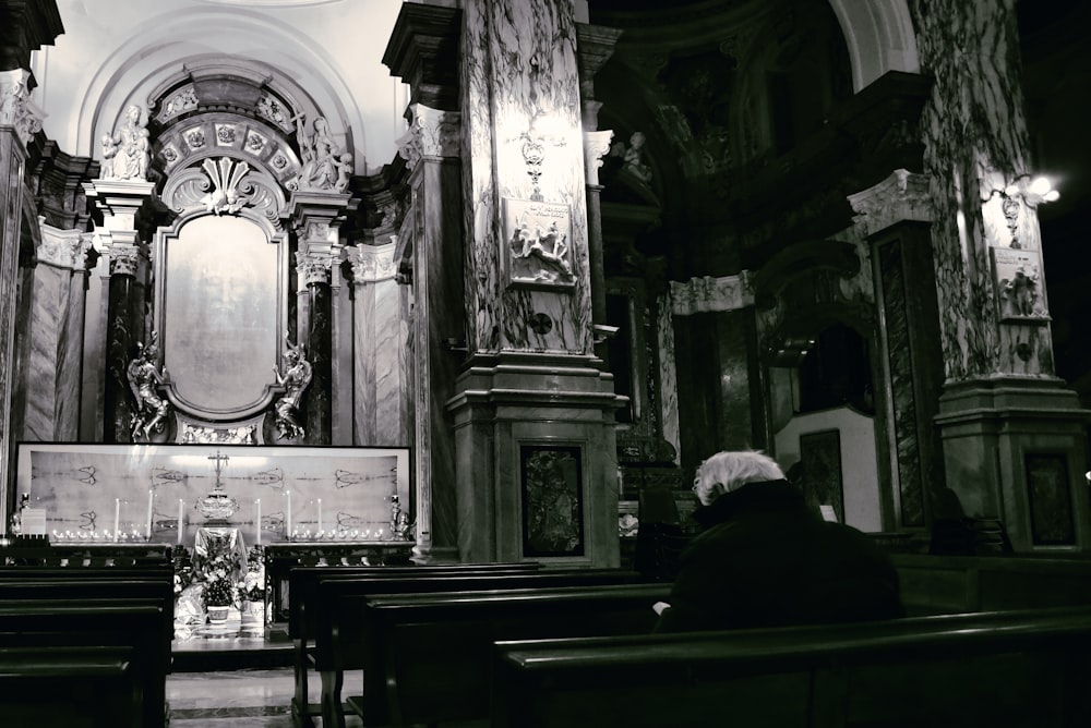 a black and white photo of a church with pews