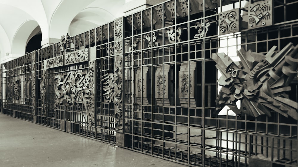 a black and white photo of a wall of art