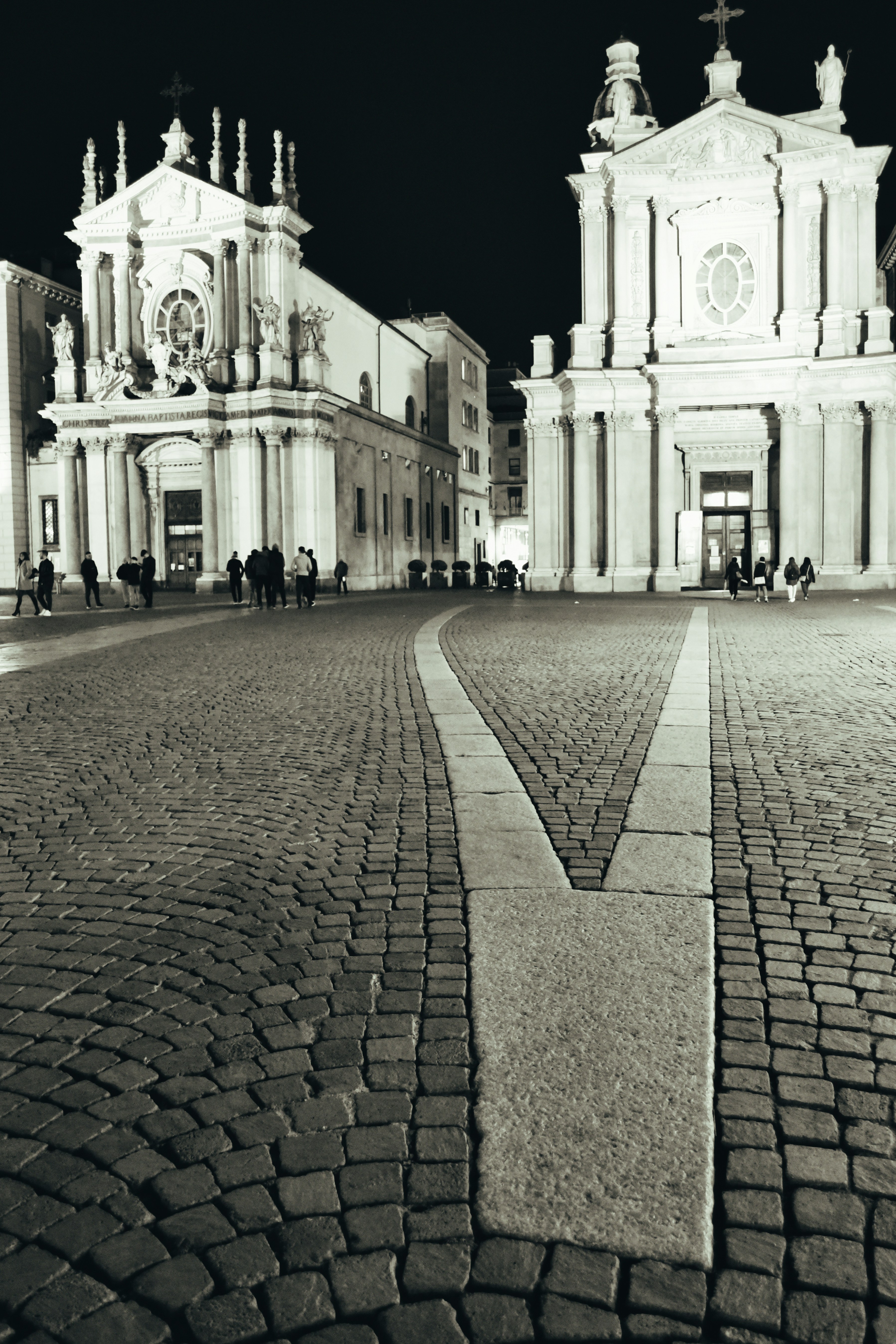 a black and white photo of a cobblestone street