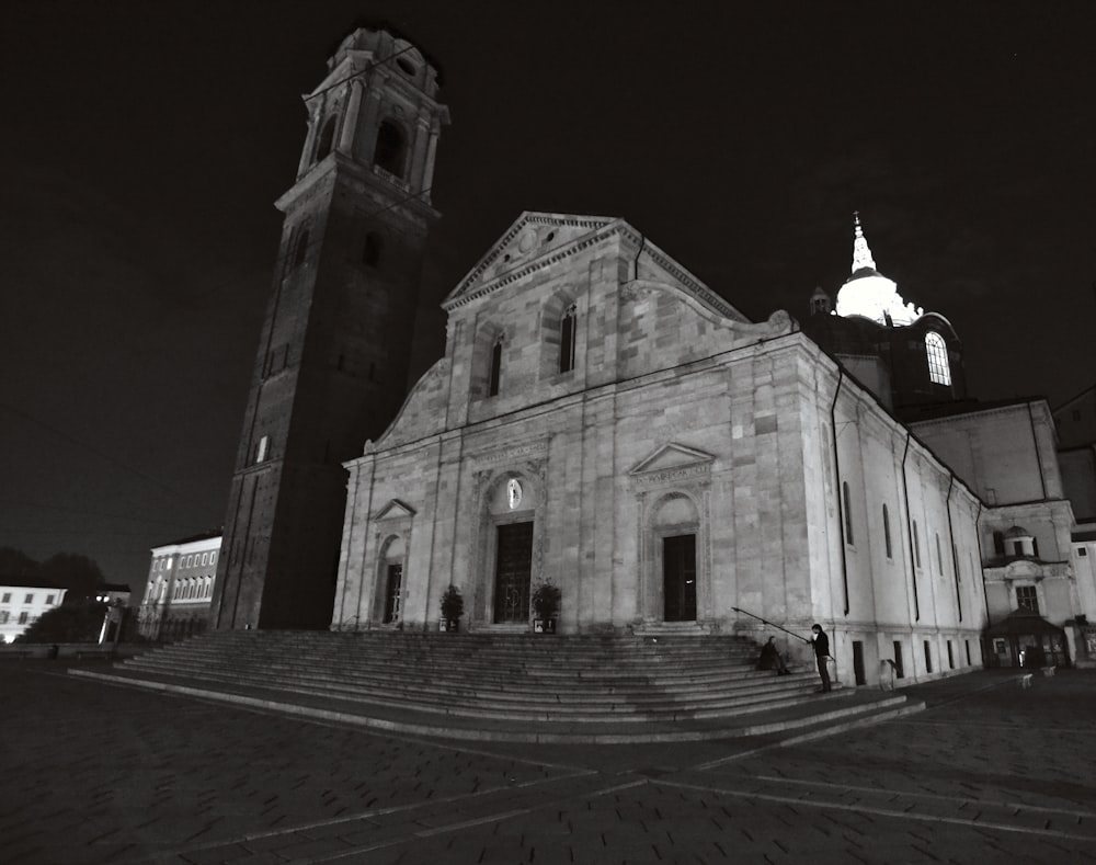 a black and white photo of a church at night