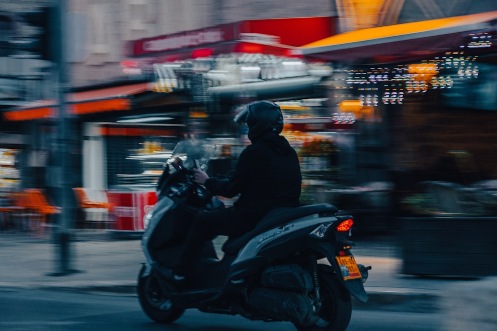 a person riding a motorcycle on a city street