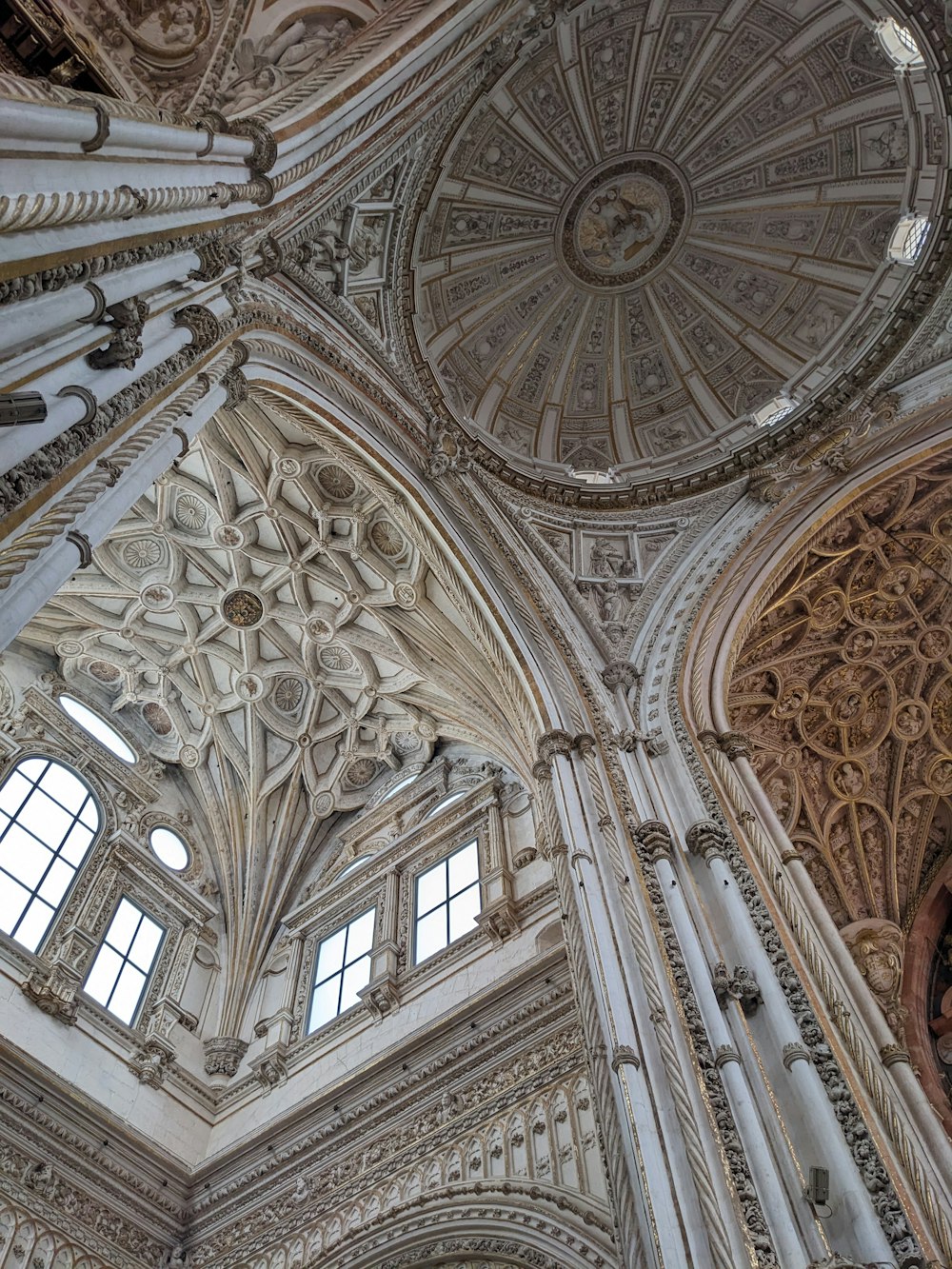 the ceiling of a large building with many windows