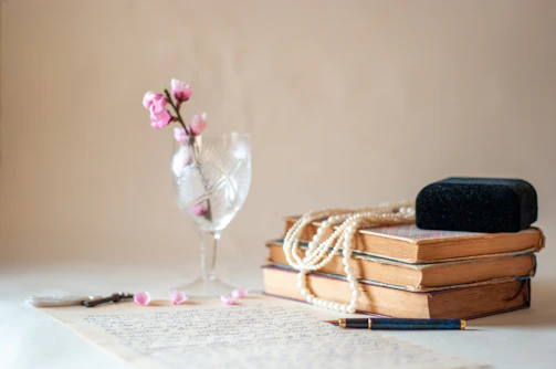 Stack of law books with a golden pen resting on top, symbolizing knowledge.