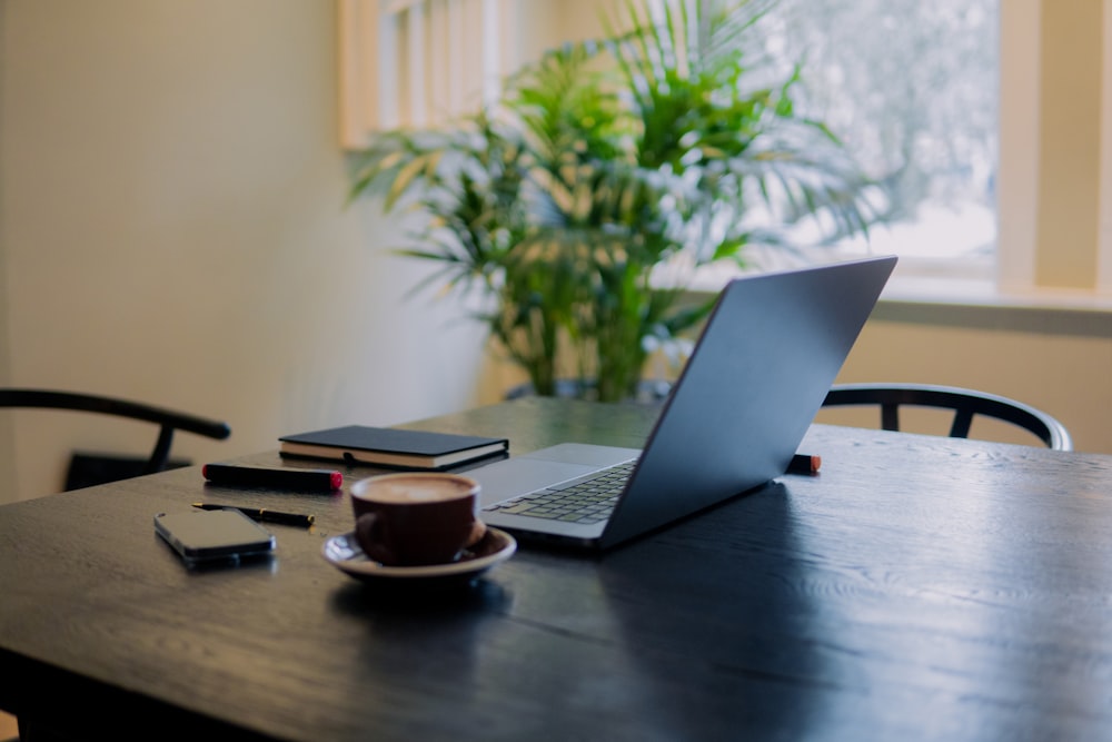 a laptop computer sitting on top of a wooden table